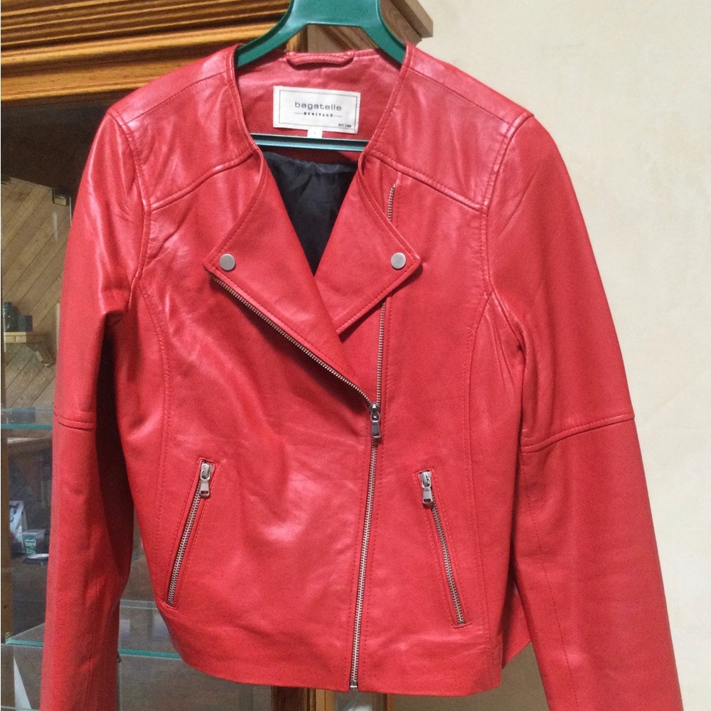 Burnt Red Leather jacket with zip sleeves and double zipper pockets.